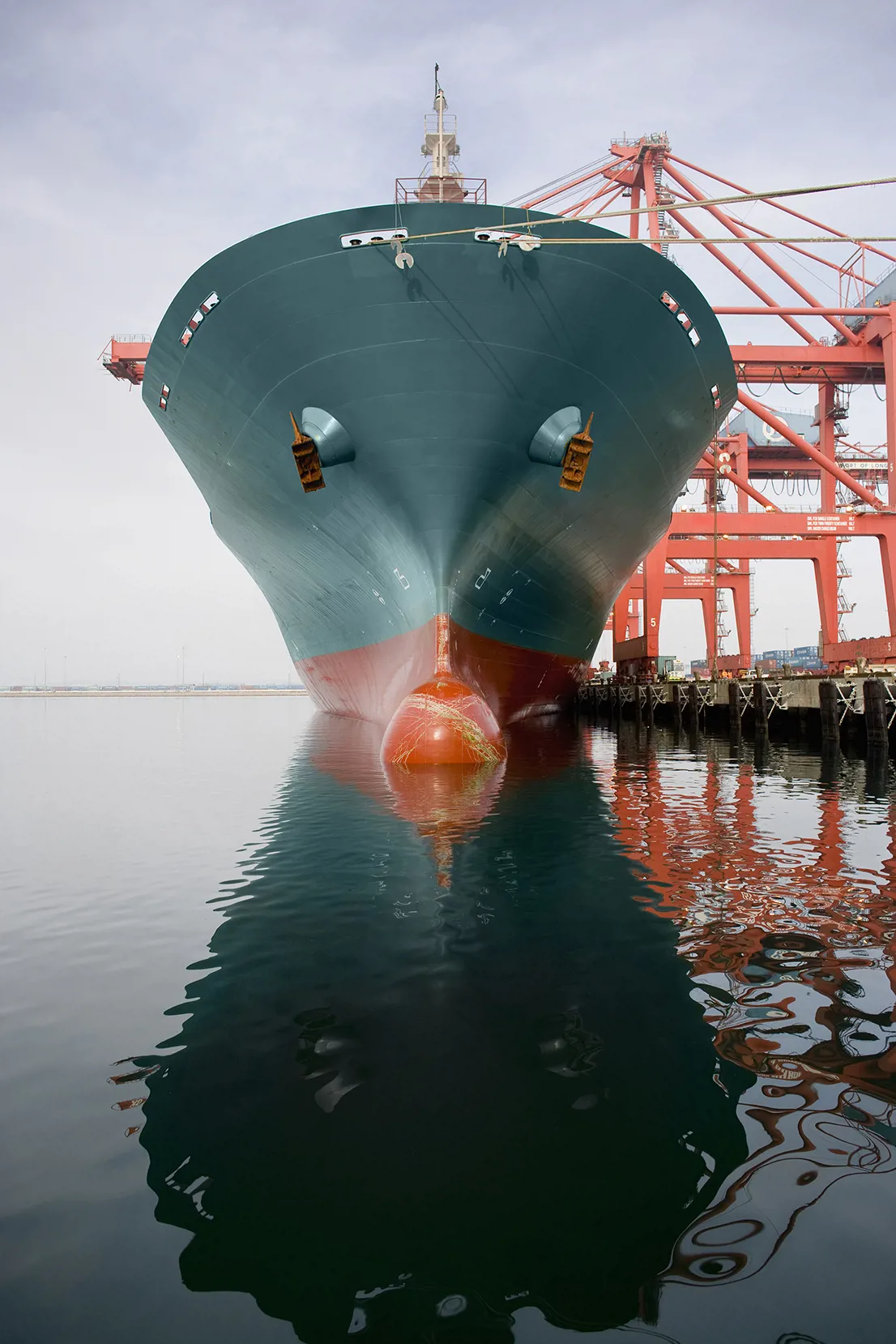 Bow of a red and teal cargo ship