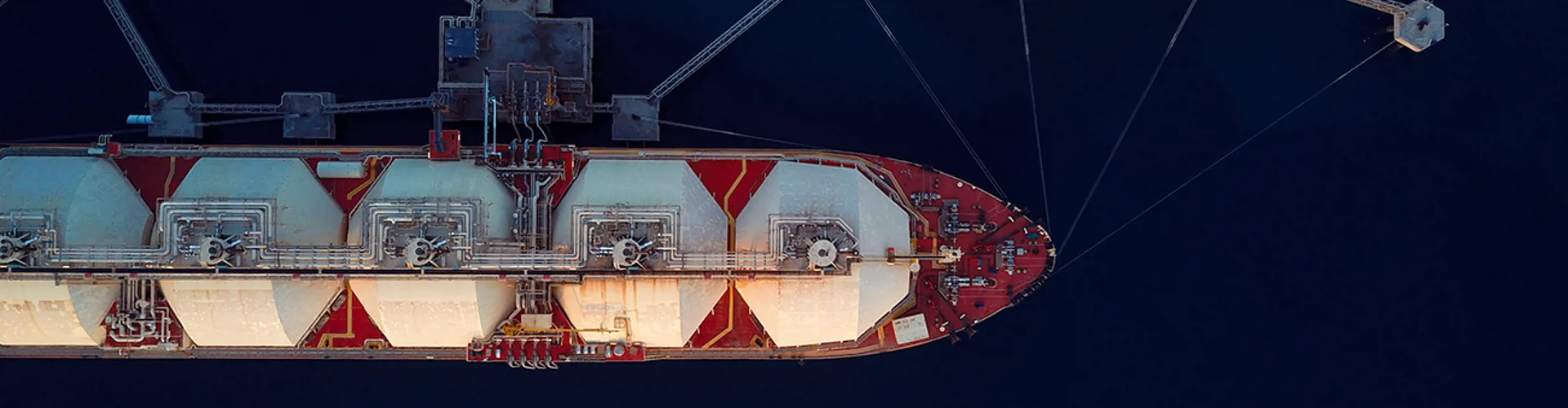 Aerial Top View Of A Liquefied Natural Gas (LNG) Tanker Moored To The Jetty