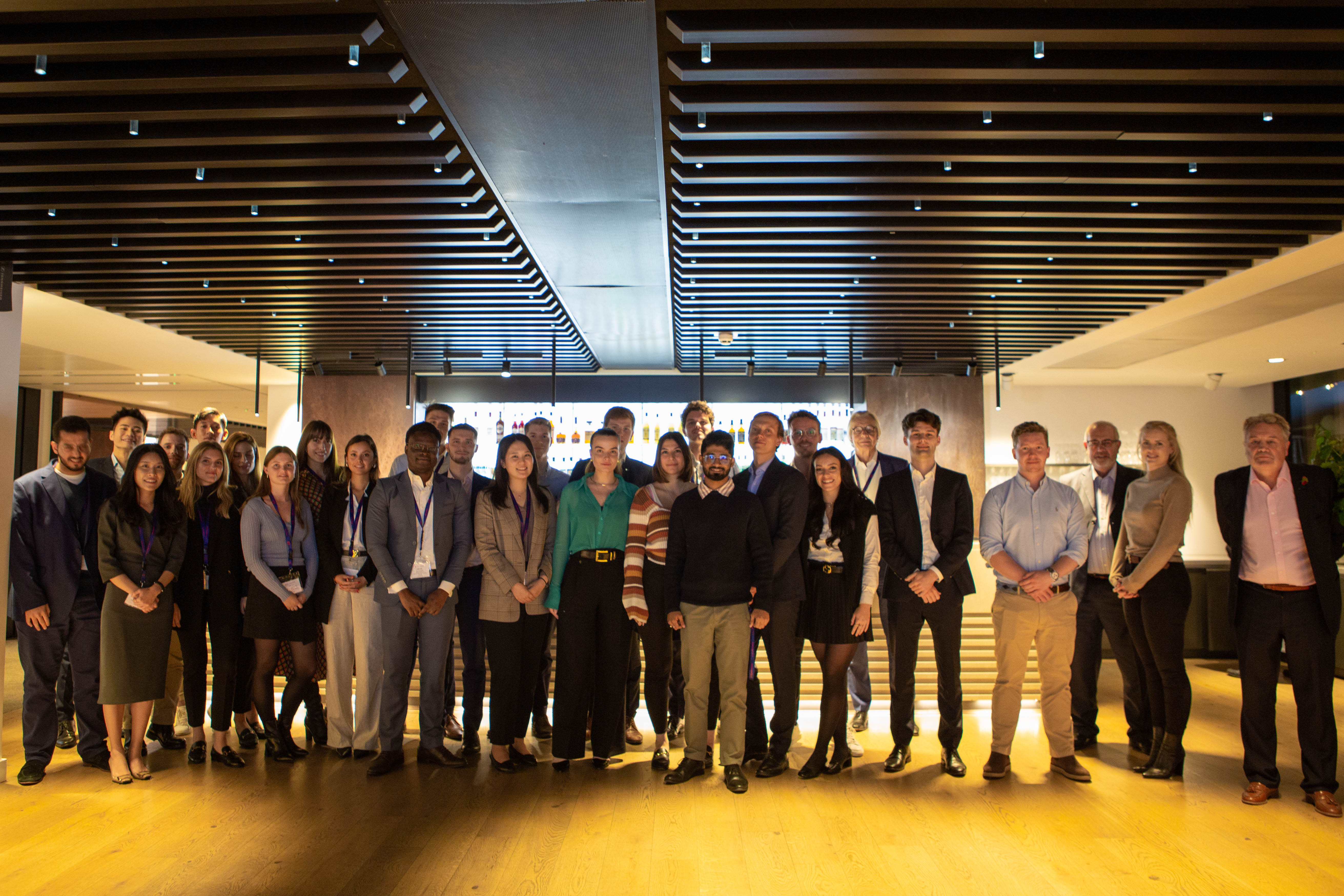 Group photo of people in a modern interior.