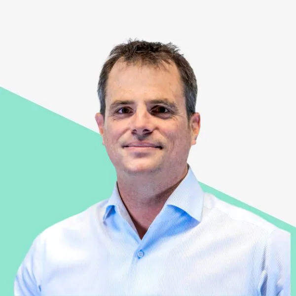 Man in a light blue shirt against a white background.