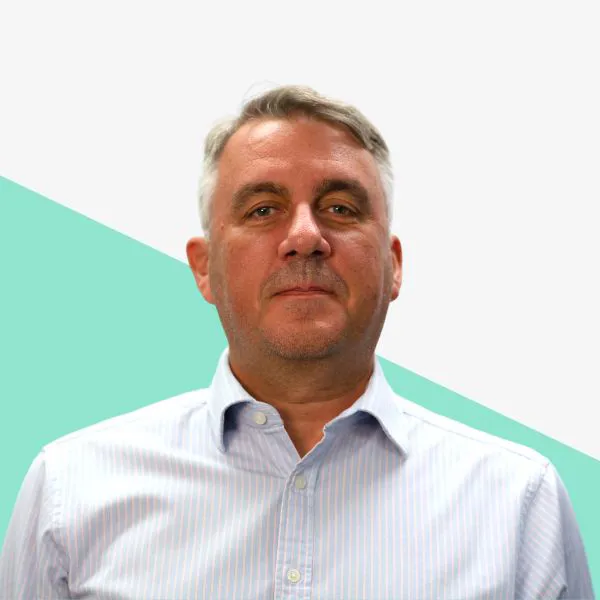 Man with short gray hair in a blue shirt.