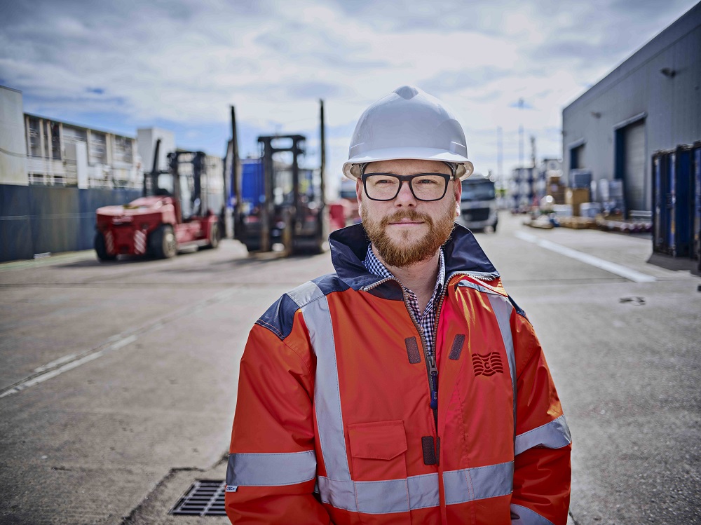 Man wearing helmet and hi vis jacket