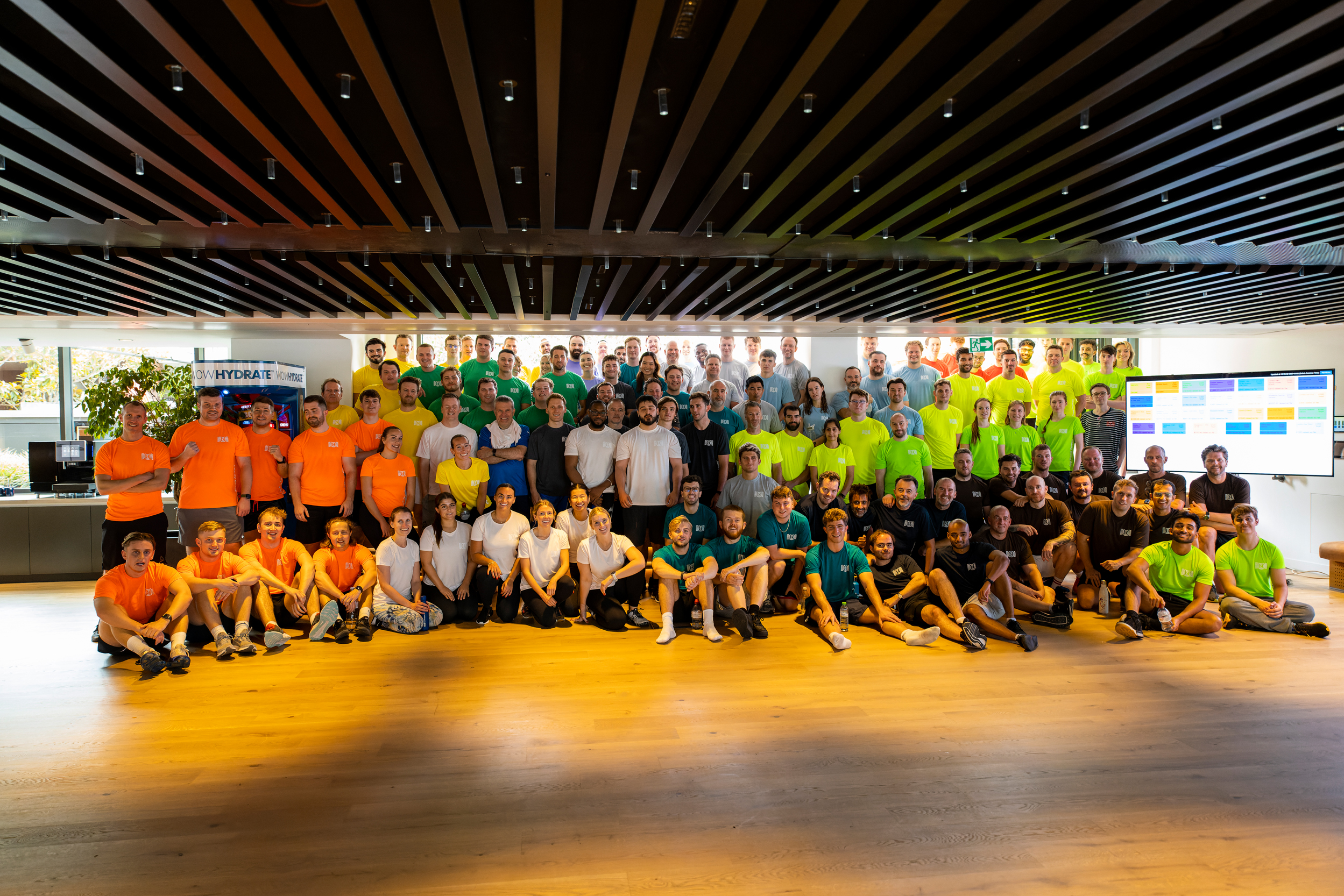 Group photo of diverse people in colorful shirts.