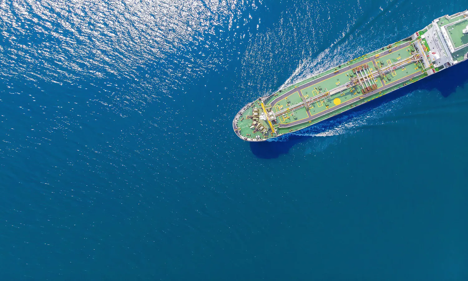 Aerial view of a ship on blue waters.