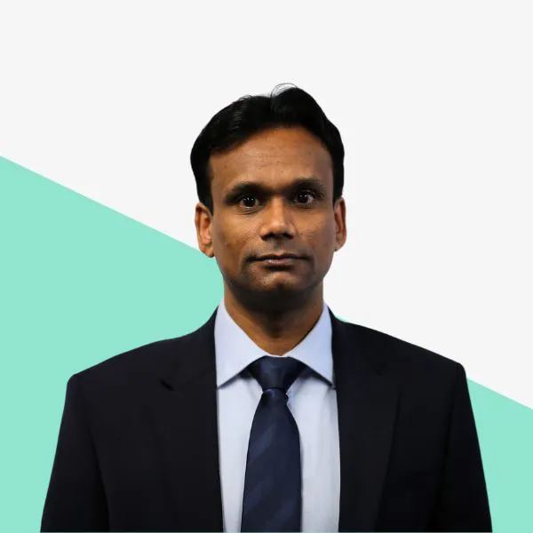 Man in a suit against a light background.