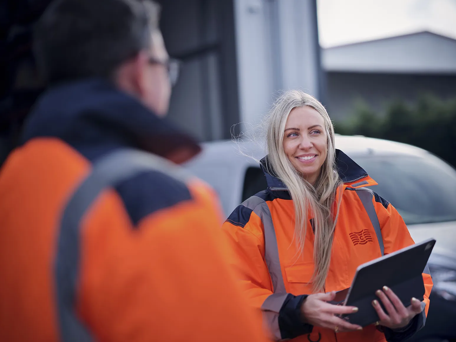 quayside employees smiling in high vis jacket