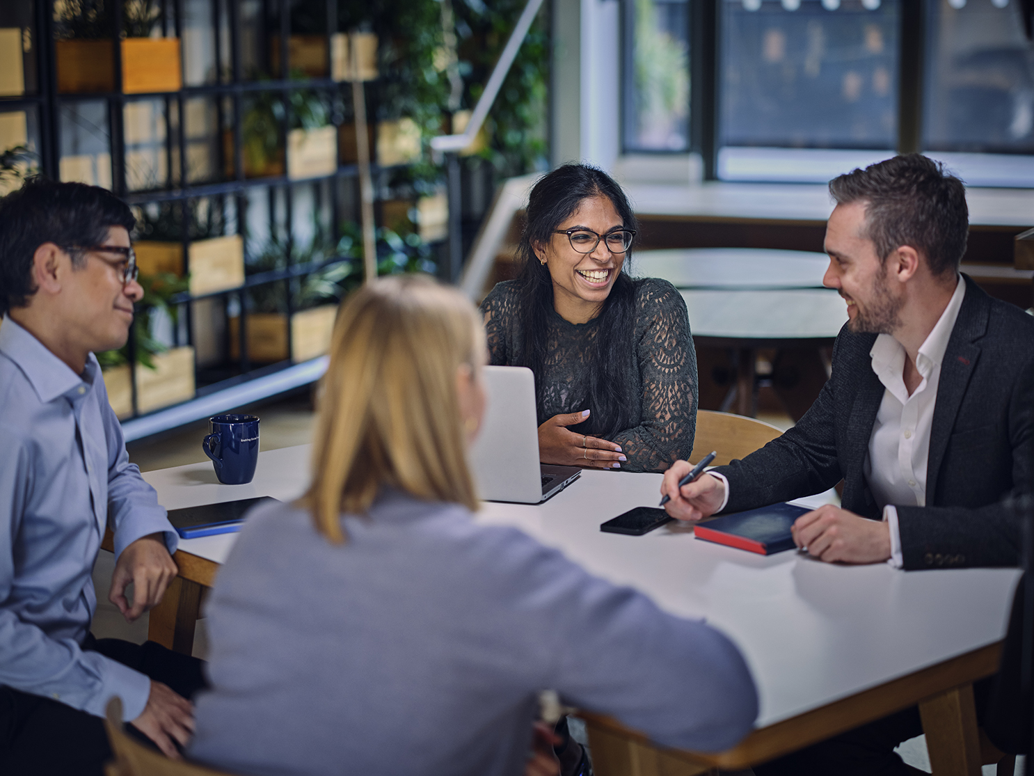 colleagues discussing work at a table
