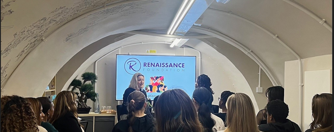 Women attending a presentation at a venue.