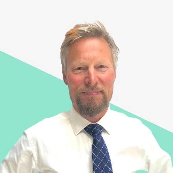 Man in a suit with light hair and beard.