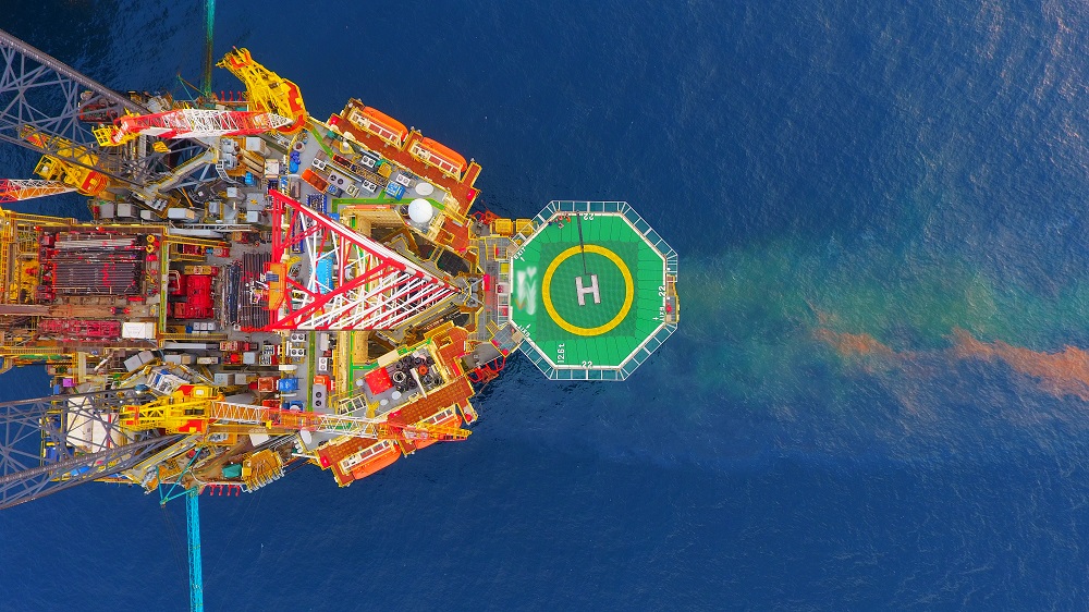 Aerial view of an offshore oil rig and helipad.