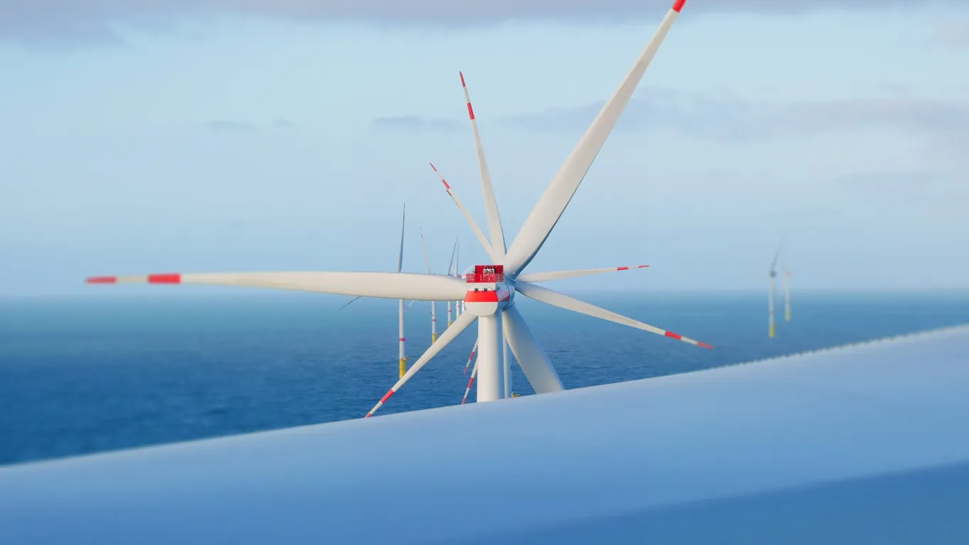 Close-up of a wind turbine over the ocean.