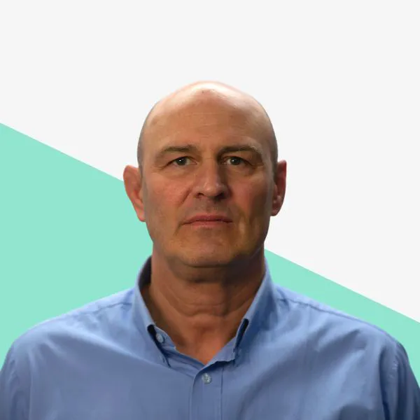 Man with a bald head wearing a blue shirt.