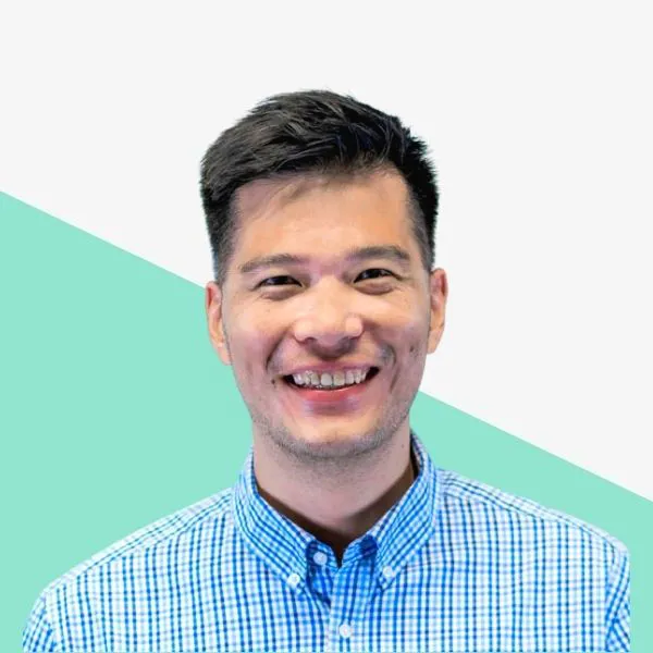 Smiling man in a blue checkered shirt.