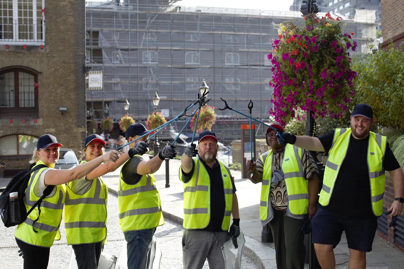 group of Clarksons employees in hi vis jackets with litter pickers