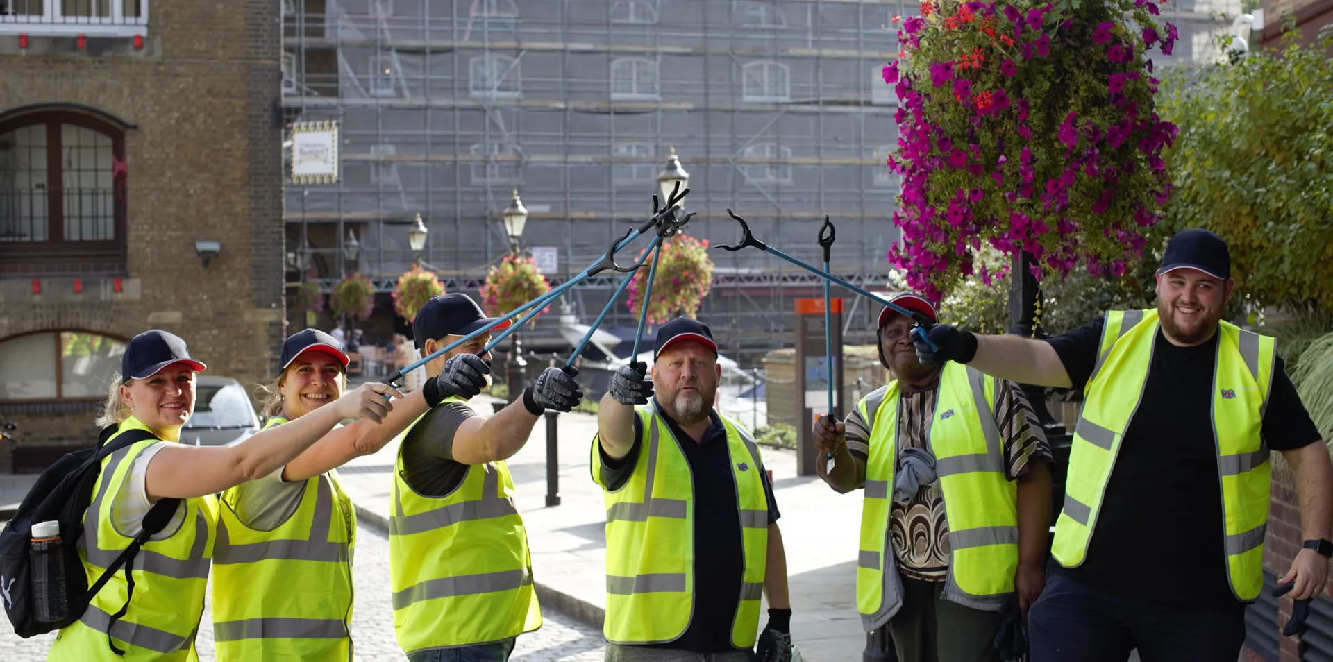 group of Clarksons employees in hi vis jackets with litter pickers