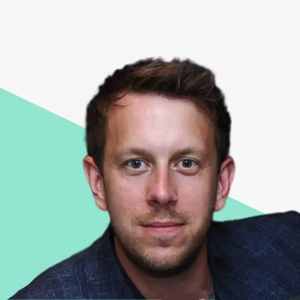 Man smiling against a light background.