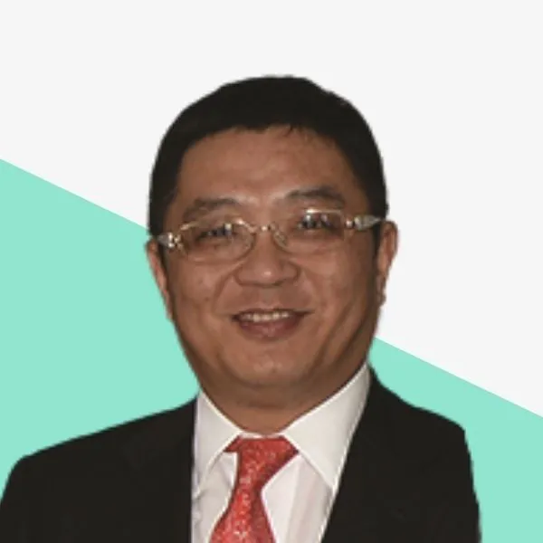 Smiling man in a suit with glasses.