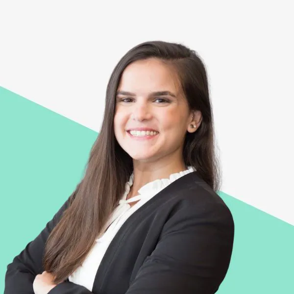 Smiling woman in a black blazer with long hair.
