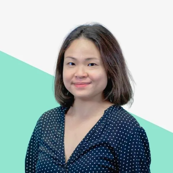 Woman with short hair wearing a polka dot shirt.
