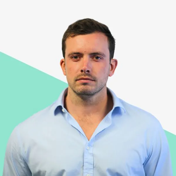 Man in light blue shirt with a serious expression.