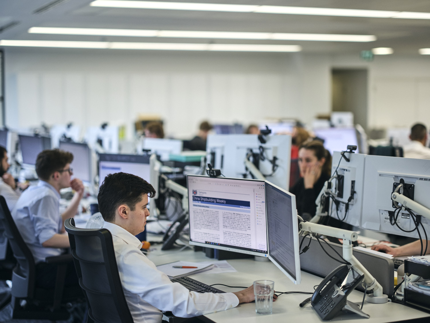 room of employees working of their computers