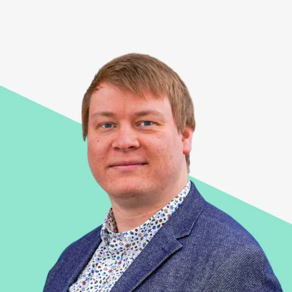 Man in a blue blazer with a patterned shirt.