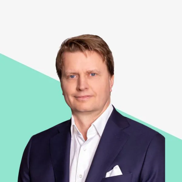 Man in a suit with a white shirt, light background.