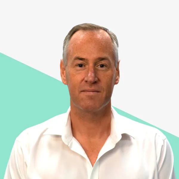 A man in a white shirt against a light background.