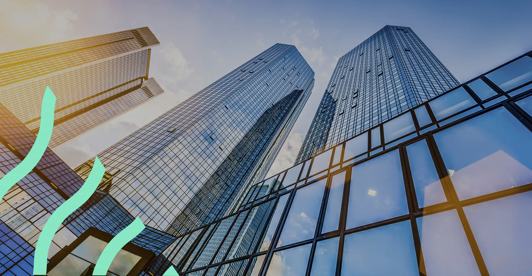 Ground up view of skyscrapers with green supergraphic