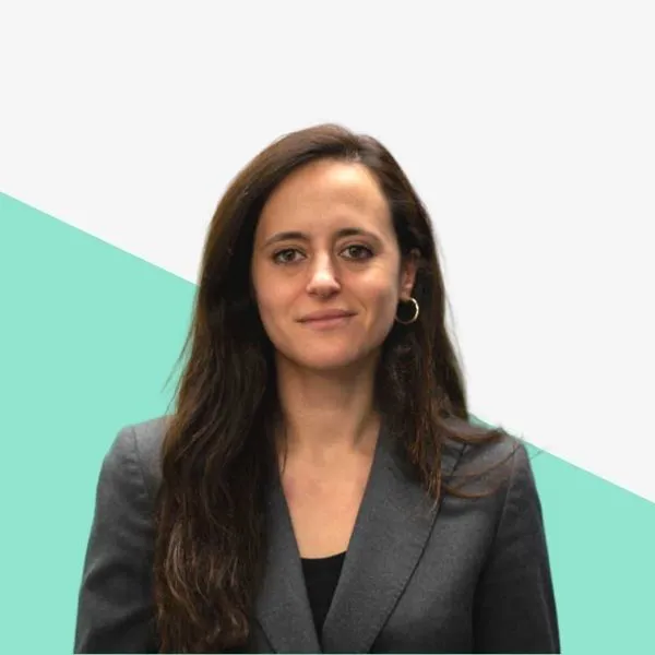 Woman in a gray suit with long hair.