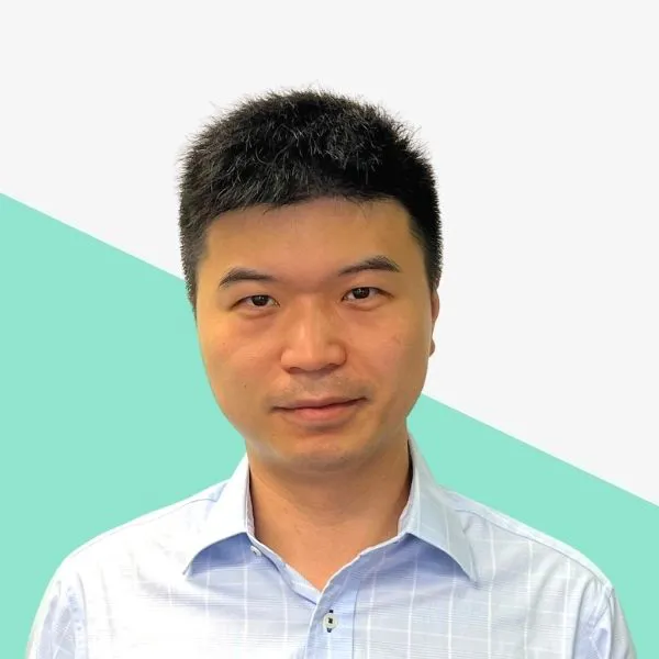 Man with short black hair in a light blue shirt.