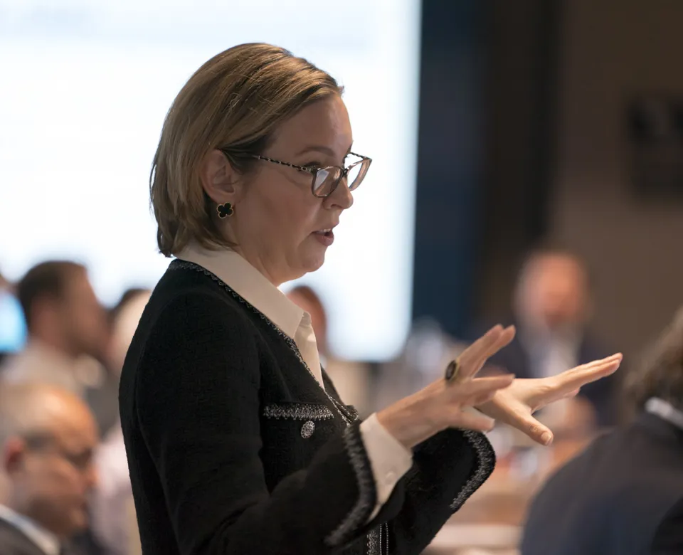 close up of woman standing talking to colleagues