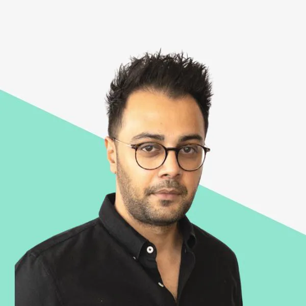 Man with glasses and short, styled hair.