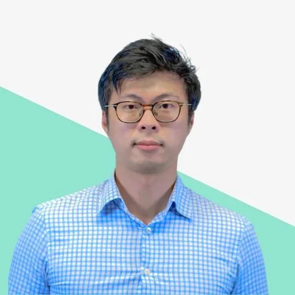 Man in a blue checkered shirt with glasses.