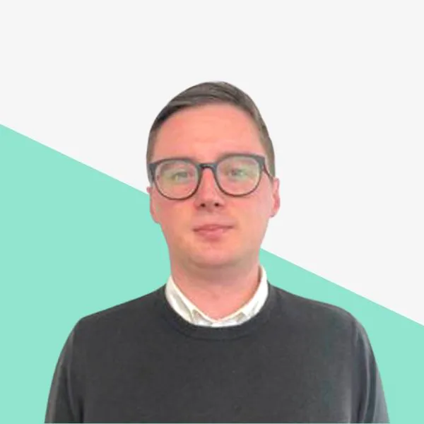 Man with glasses against a abstract background.