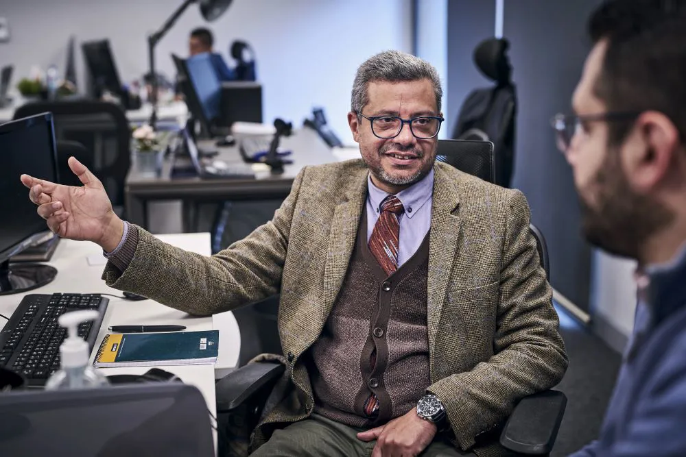 Close up of a man explaining something to a colleague