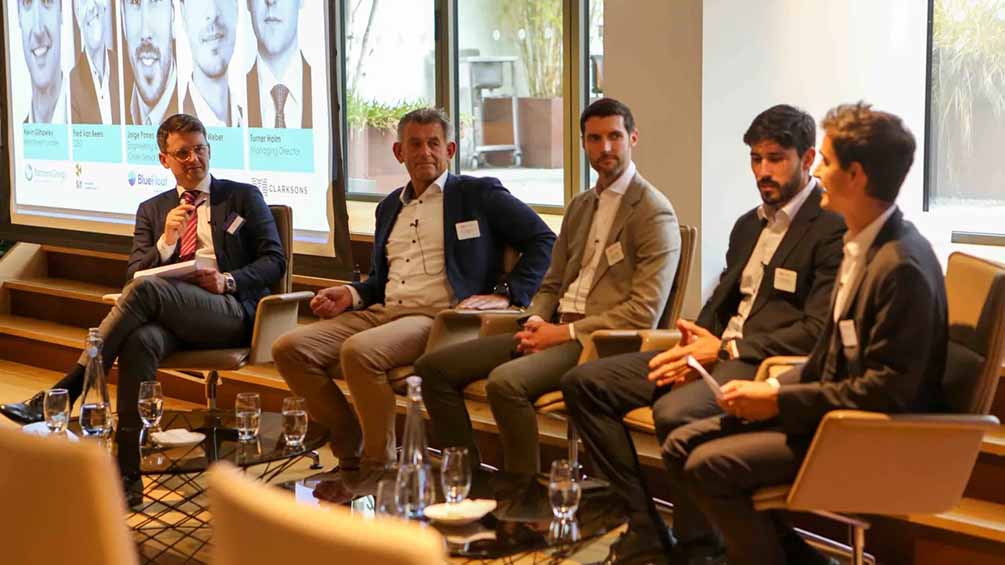four men sitting at a panel discussion