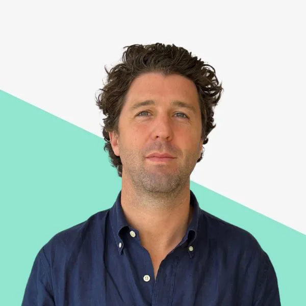 Man with curly hair in a blue shirt.