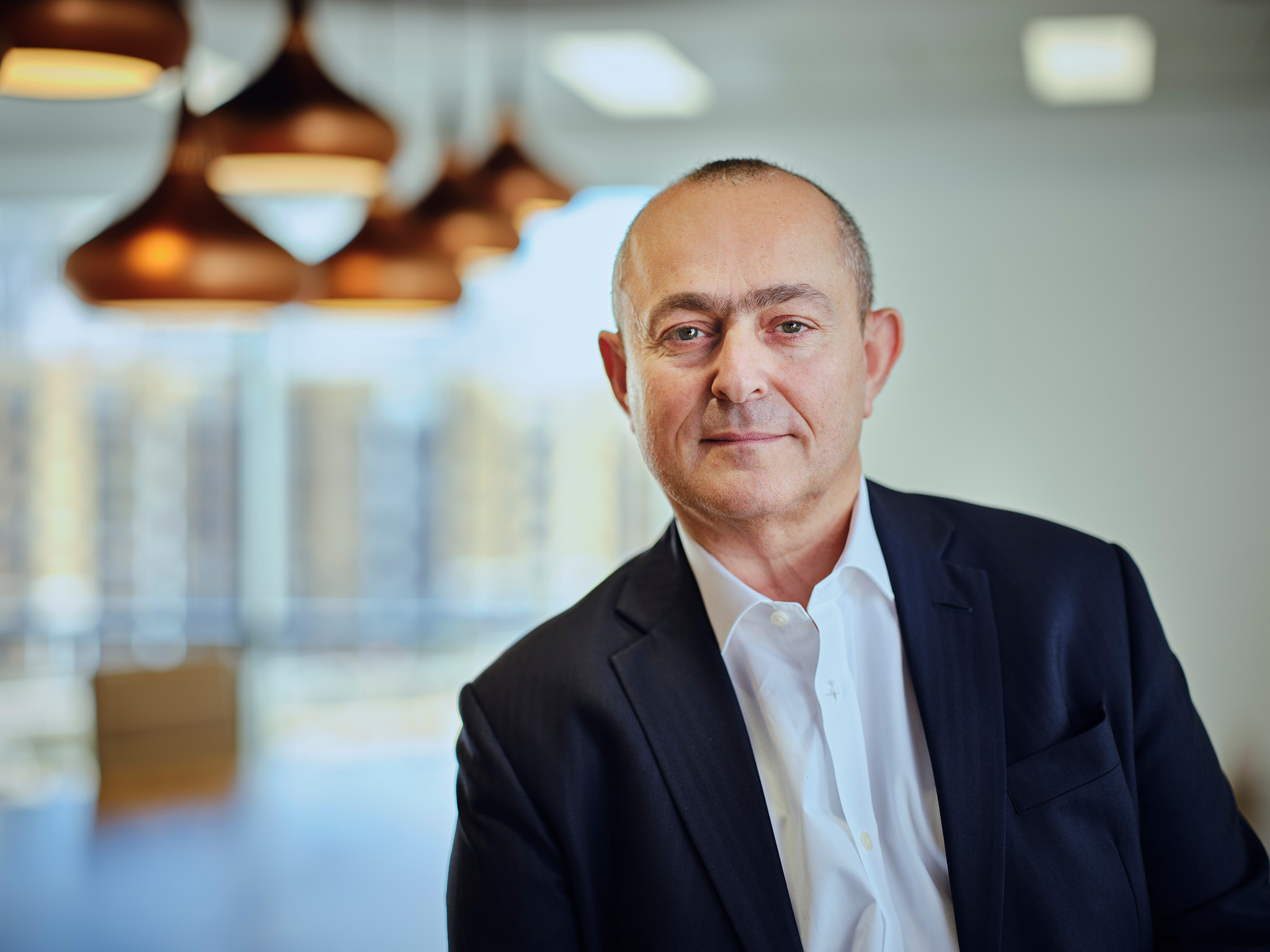 A man in a suit in an office setting.