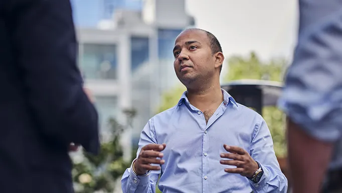 man talking to two other people