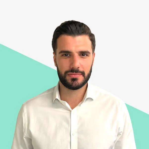 Man in a white shirt against a gradient background.