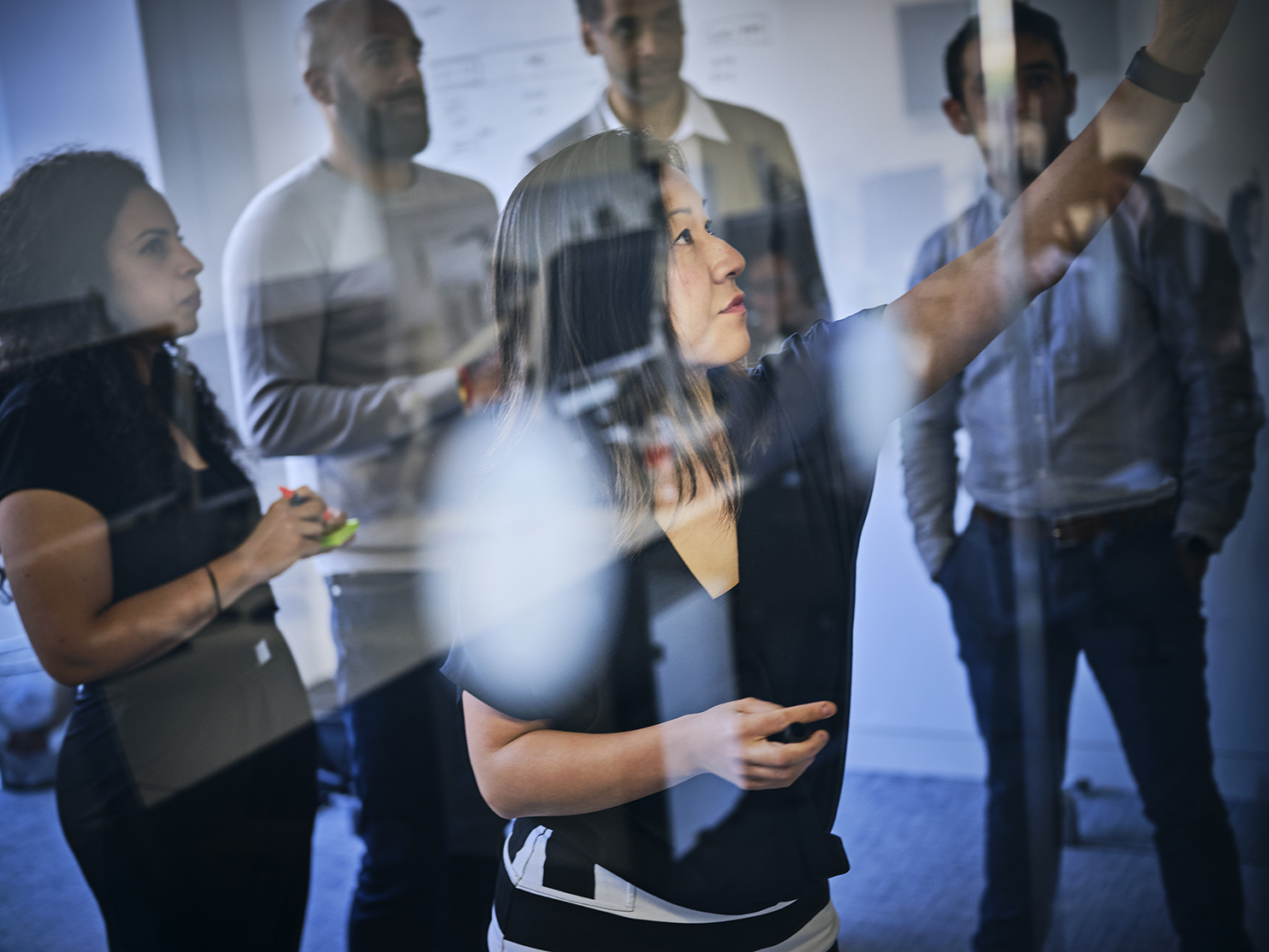 colleagues in a meeting room discussing new ideas and brainstorming