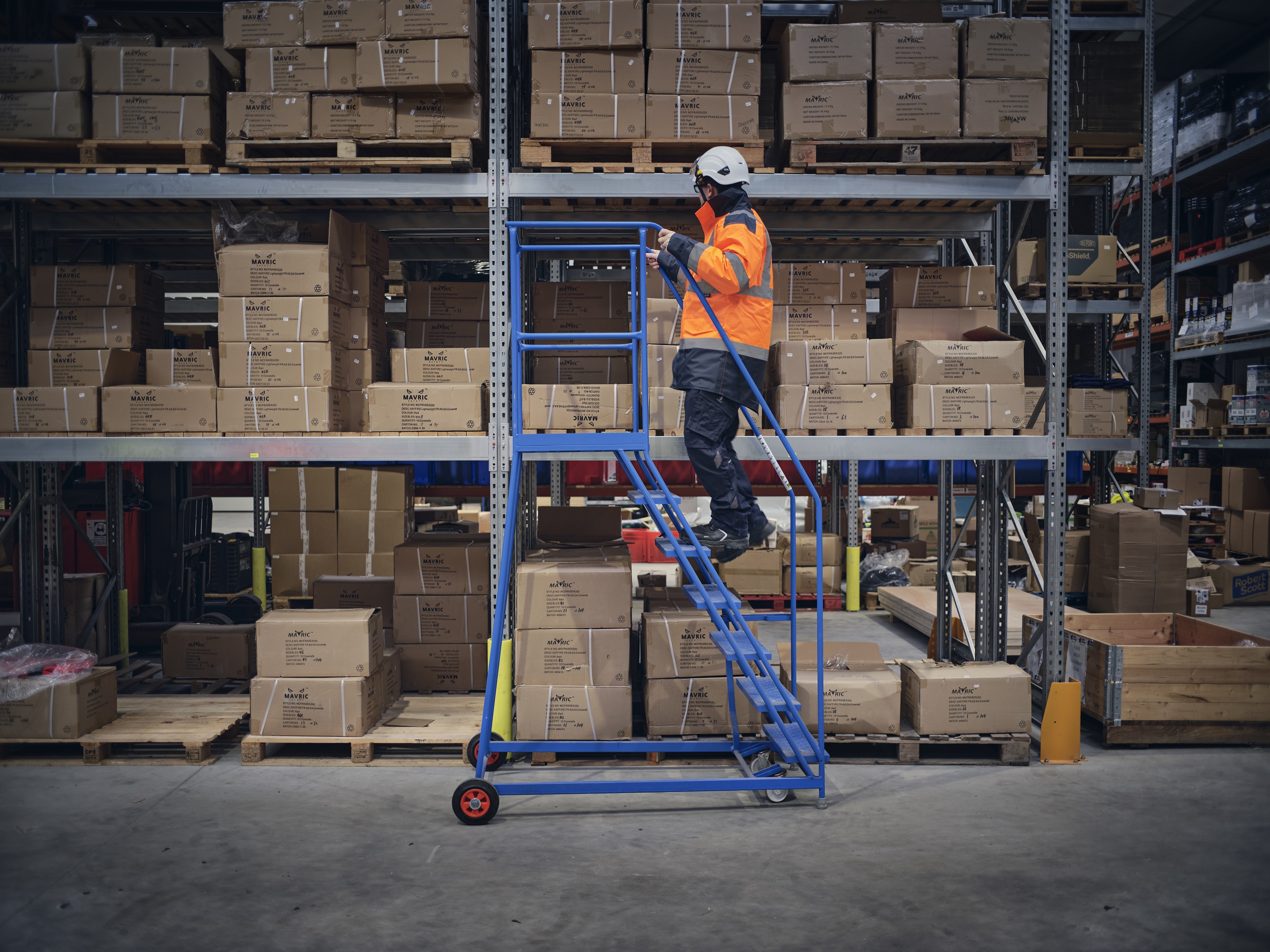 warehouse employees on a ladder checking stock