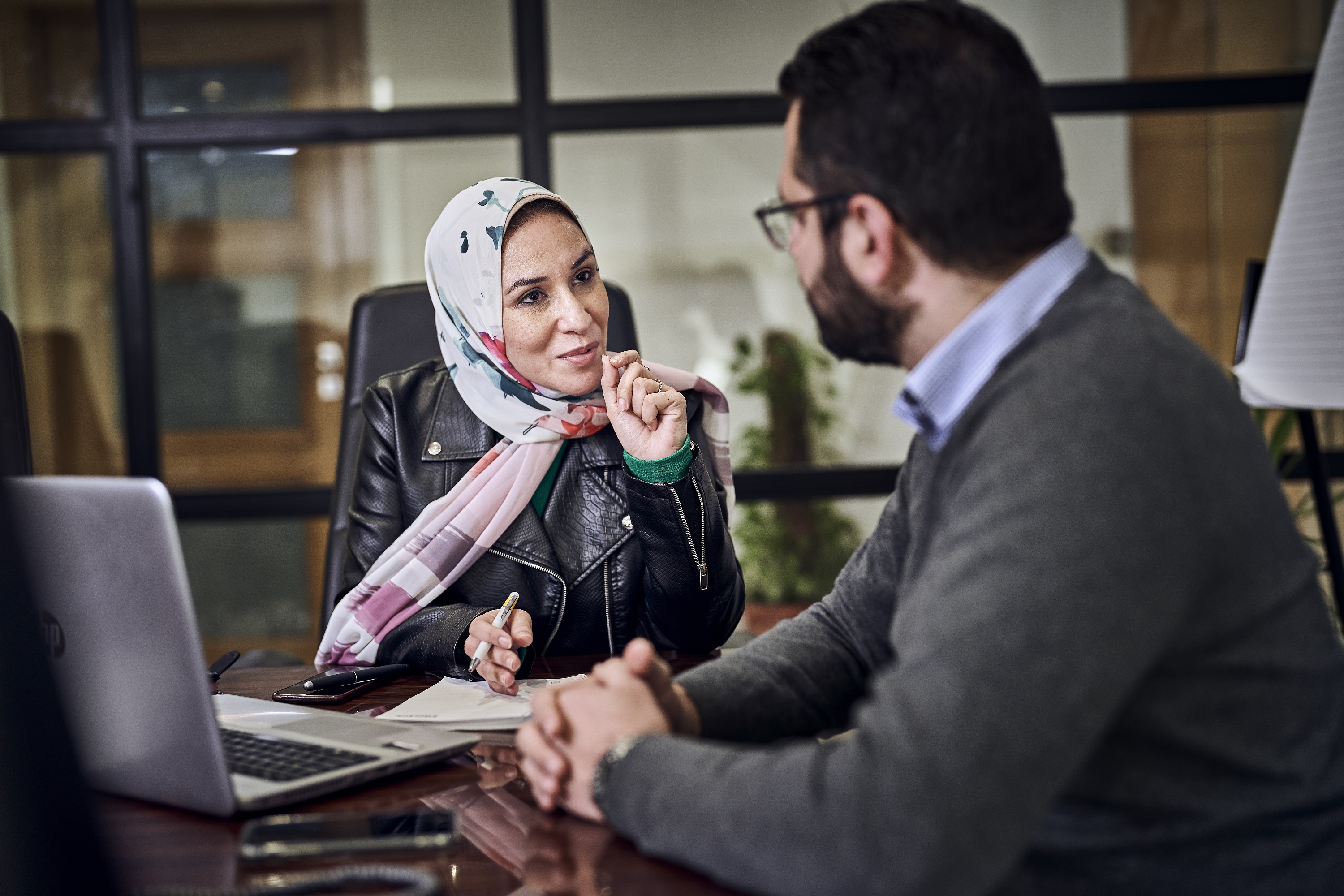 woman talking to a colleague and gesturing with her hands
