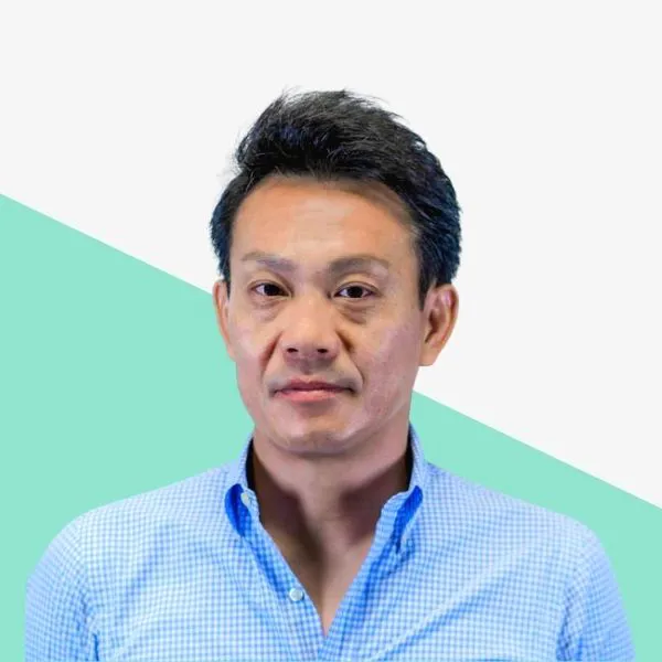 Man in a blue checkered shirt against a light background.