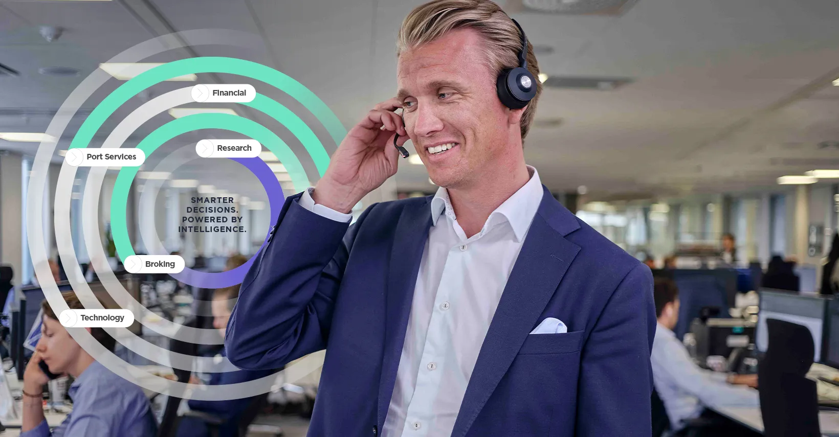 Man in a suit using a headset in an office.
