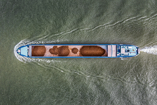 Cargo container ship at sea, top down Aerial view, freight business with beautiful wave pattern for logistics, import export, shipping or transportation