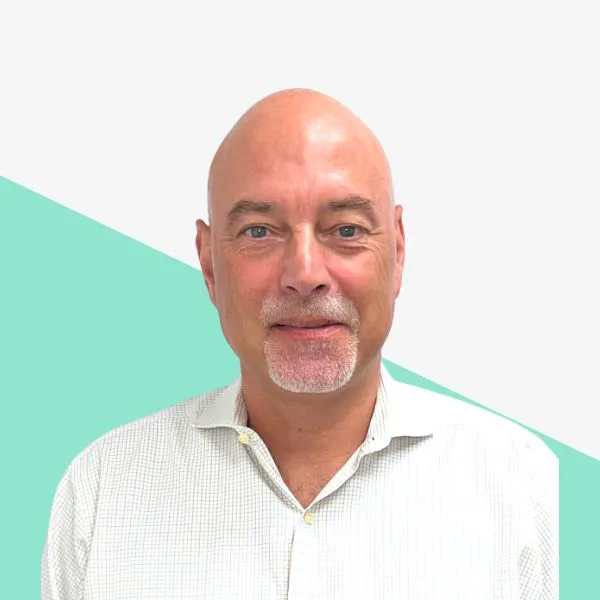 Smiling man with a bald head and beard.