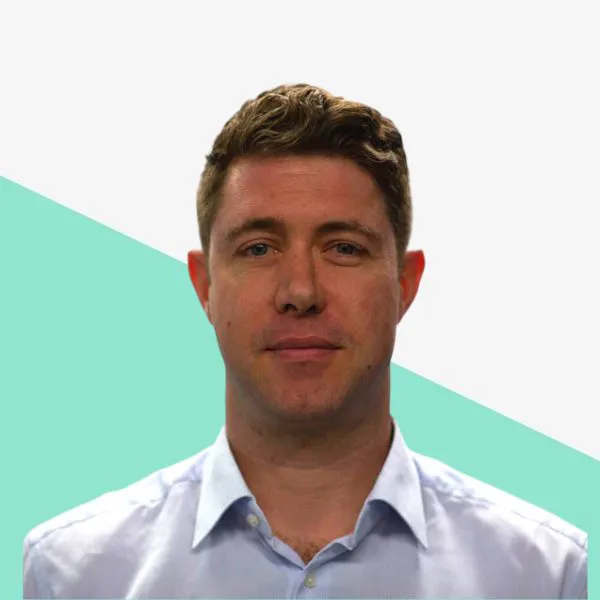 Man with short hair wearing a light blue shirt.