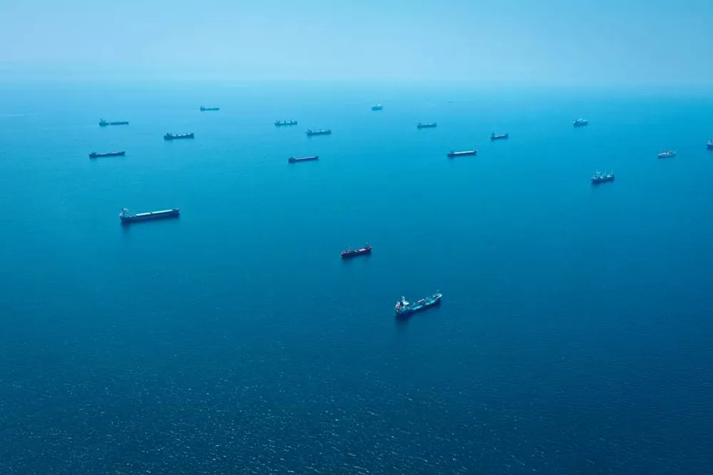 Multiple ships on a calm blue sea.